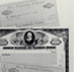 Photo of original stock certificates with a modern AT&T certificate.