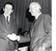 Photo of Charles Brown and William Baxter shaking hands.